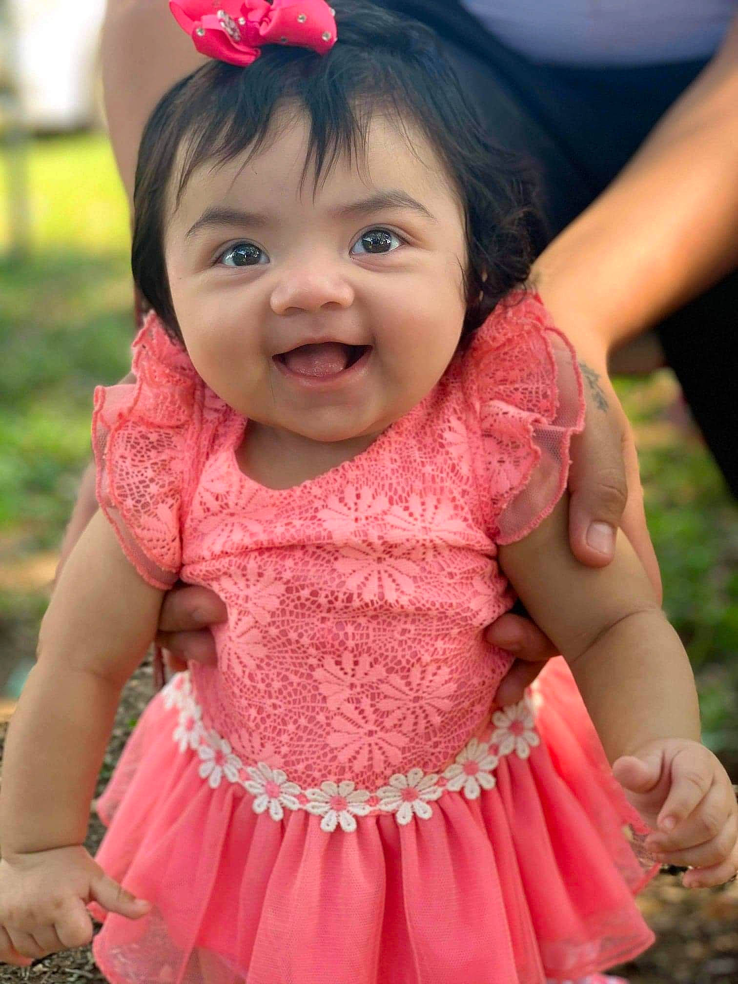 Emberlee is registered to the contest to win money with this photo: baby, baby_toddler_clothing, child, facial_expression, finger, gesture, happy, headgear, iris, lip, neck, person, photograph, pink, red, skin, sleeve, smile, toddler, white