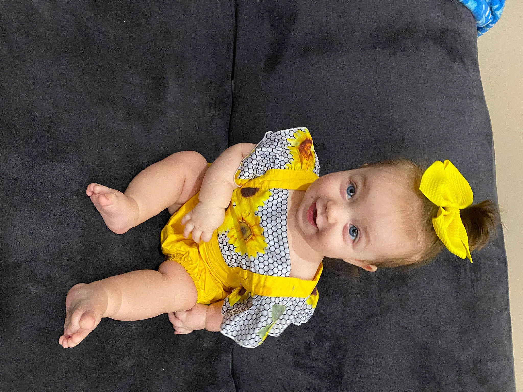 Coral is registered to the contest to win money with this photo: baby, baby_products, baby_toddler_clothing, cheek, child, comfort, foot, fun, grass, happy, hat, human_leg, iris, joy, pattern, person, sitting, skin, sleeve, smile