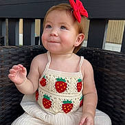 Jaylene is registered to the contest to win money with this photo: toddler, child, smile, red_bow, strawberry_pattern, crochet_top, white_pants, wicker_chair, outdoor, tree, wooden_fence, cute, portrait, baby, sitting, happy, earrings, short_hair, natural_light, casual_clothing