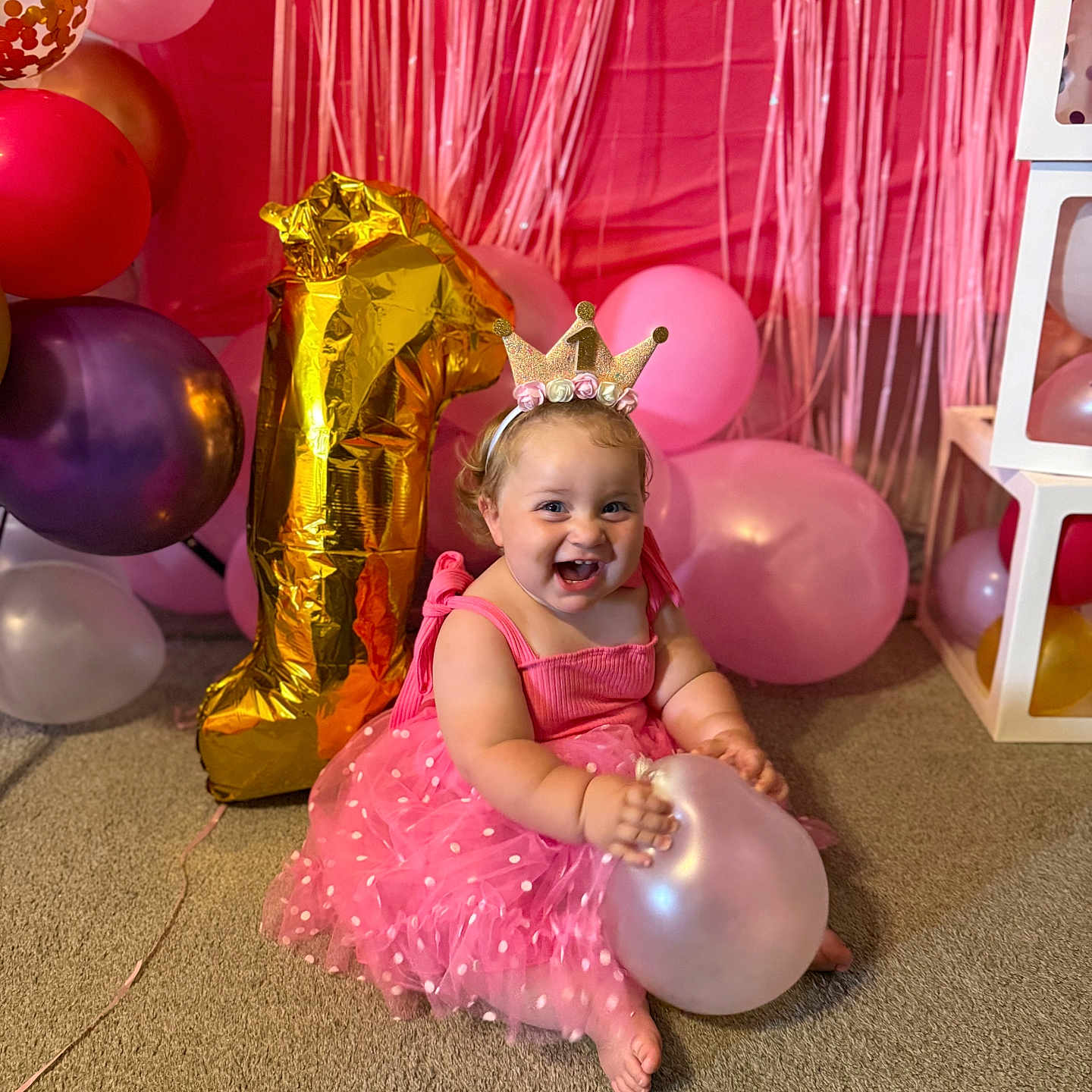 Hadlie joined the competition — help win amazing prizes! baby, balloon, birthday, carpet, celebration, cheerful, child, crown, decorations, dress, floor, fun, happy, headband, indoors, number_one, party, pink, smile, toddler