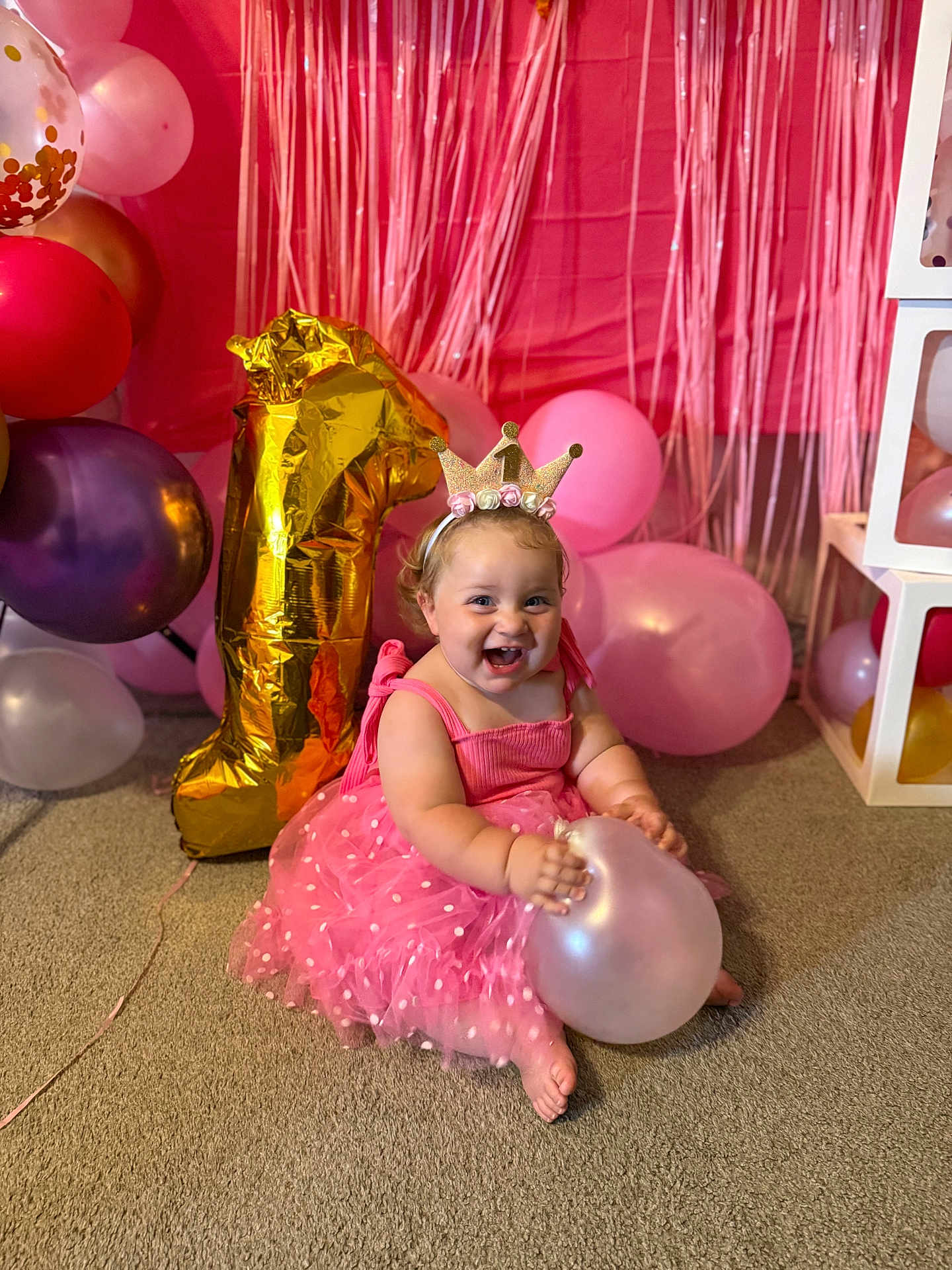 Hadlie joined the competition — help win amazing prizes! baby, birthday, balloon, pink, dress, crown, celebration, smile, happy, child, party, decorations, floor, indoors, number_one, headband, carpet, toddler, cheerful, fun