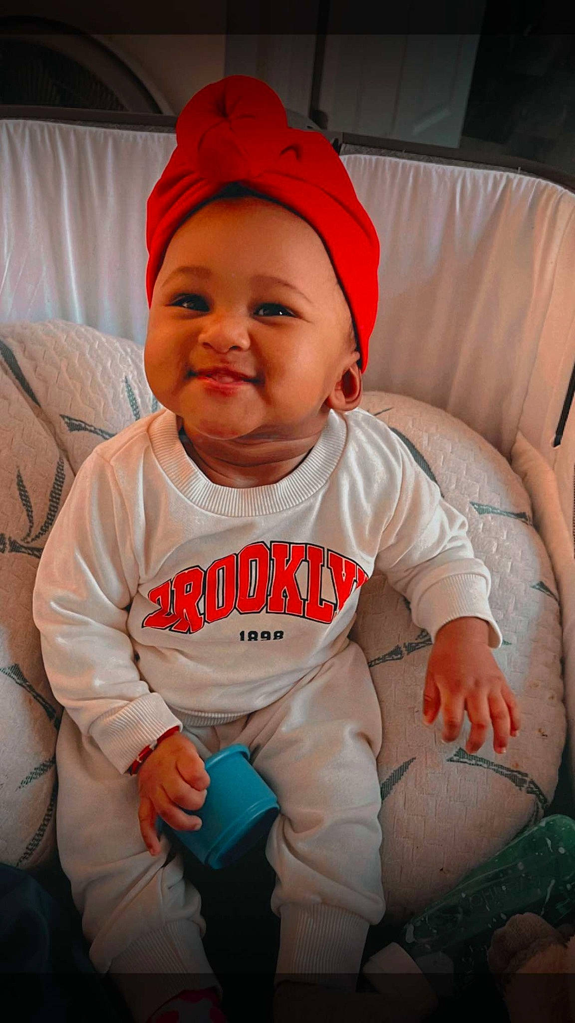 Brooklynne is registered to the contest to win money with this photo: baby, baby_toddler_clothing, cap, cheek, comfort, cool, eye, face, facial_expression, finger, happy, head, headwear, human_body, joy, lip, mouth, person, pink, product