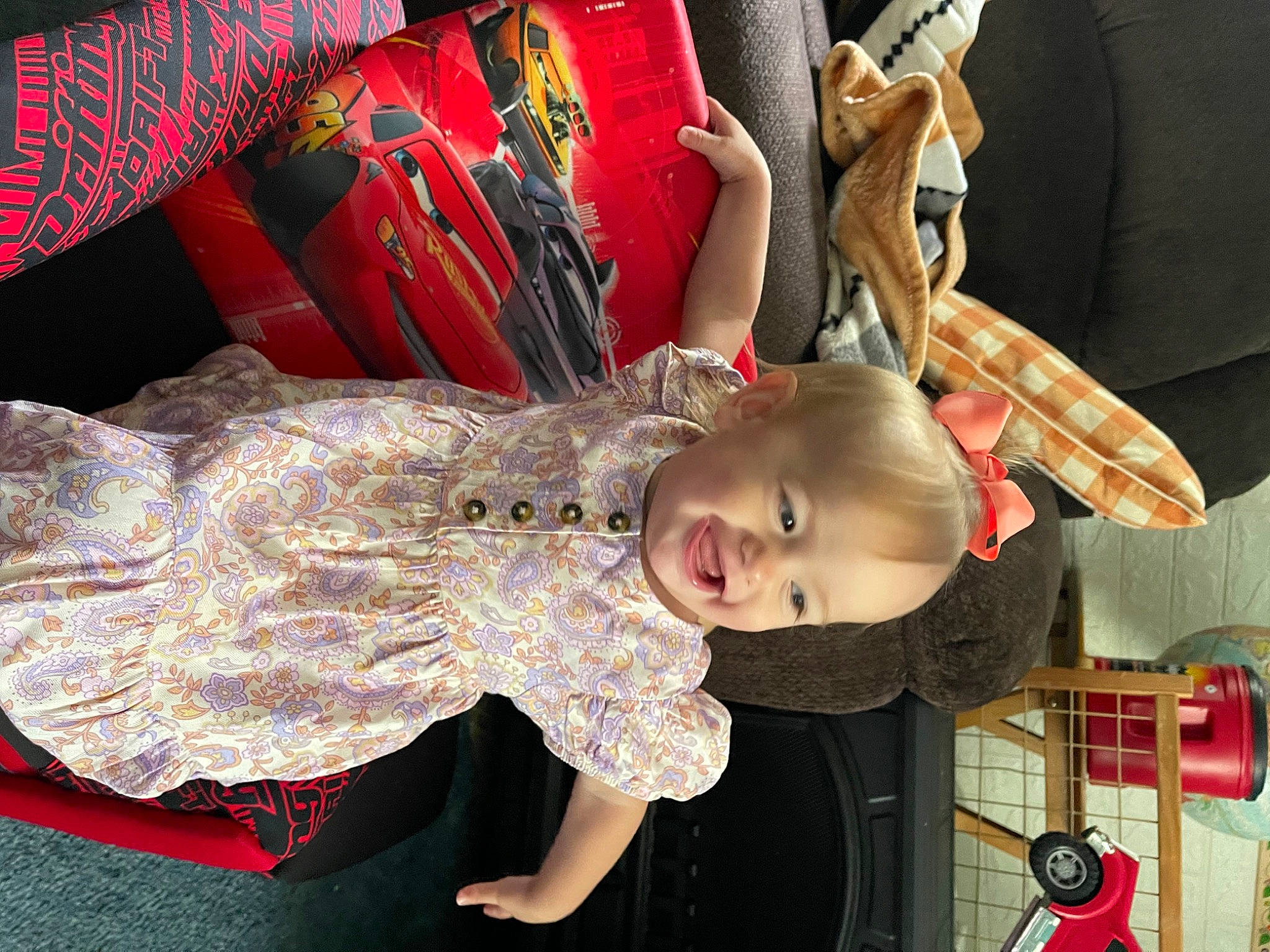Maddelynn is registered to the contest to win money with this photo: baby, baby_products, baby_toddler_clothing, child, costume, event, fashion_accessory, fun, pattern, person, room, smile, toddler, toy, tree
