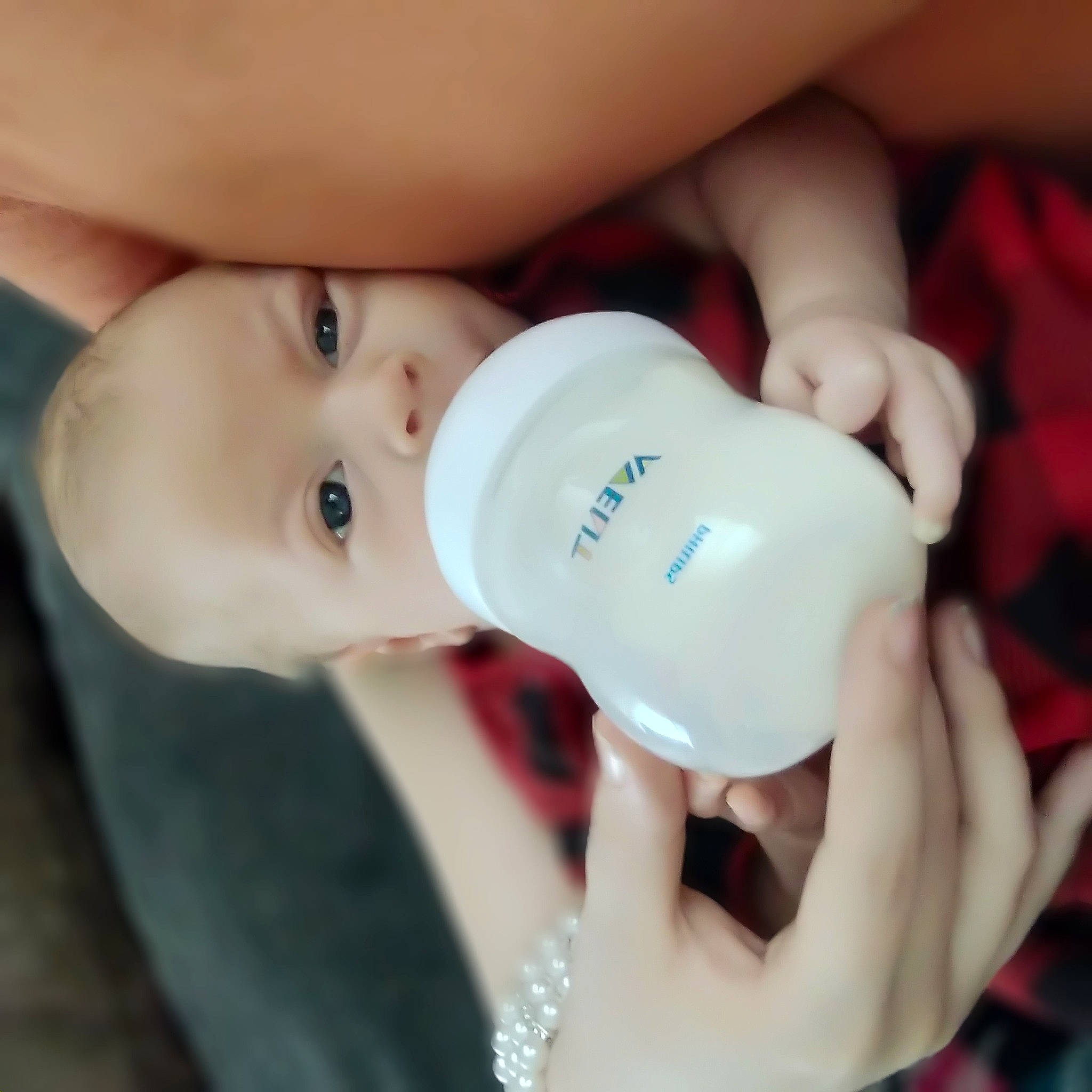 Alora joined the competition — help win amazing prizes! baby_bottle, cheek, chin, drinkware, ear, eye, eyebrow, eyelash, face, finger, fluid, gesture, hand, head, iris, lip, neck, nose, person, plastic_bottle