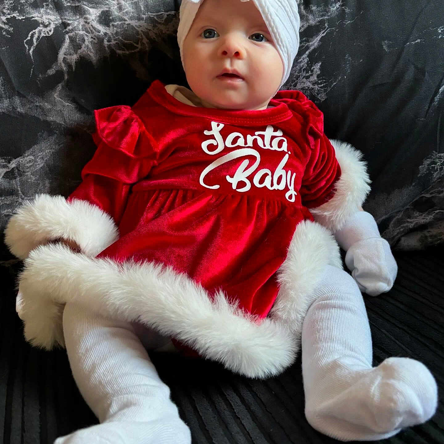 Ember is registered to the contest to win money with this photo: baby, blanket, cap, clothing, costume, couch, cushion, dress, face, furniture, hat, head, pants, person, photography, portrait, sitting, sleeve, t_shirt, toy