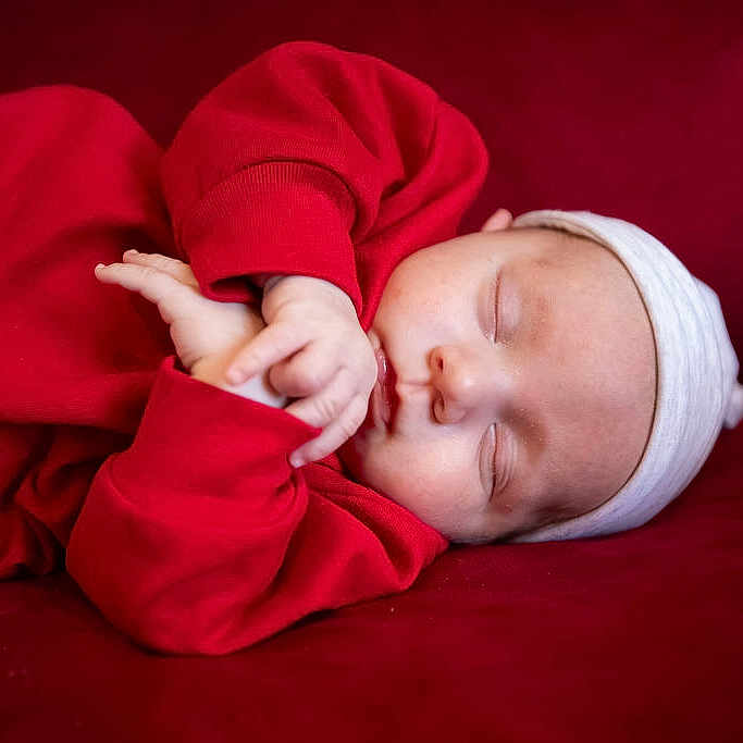 Ashton is registered to the contest to win money with this photo: baby, blanket, bodypart, bonnet, clothing, cushion, face, finger, furniture, hand, hat, head, homedecor, hood, hoodie, newborn, person, photography, portrait, sleeping