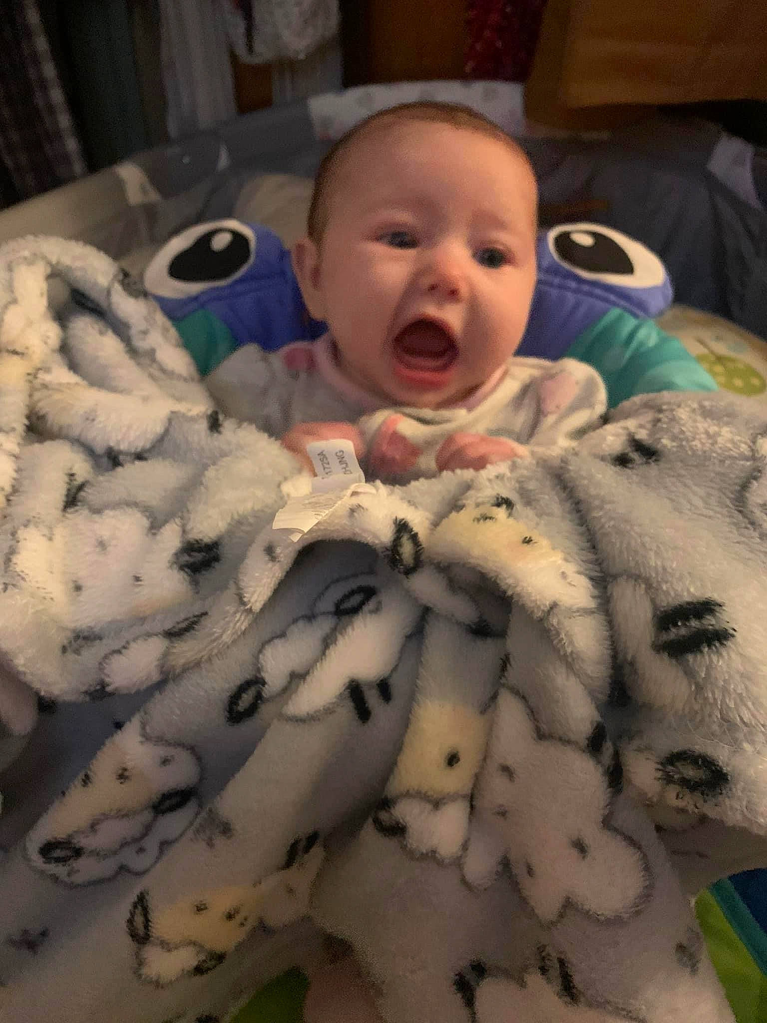 Ainsley is registered to the contest to win money with this photo: baby, baby_toddler_clothing, beauty, bedding, cheek, comfort, eye, fun, head, human_body, iris, linens, mammal, mouth, pattern, person, skin, smile, textile, toddler