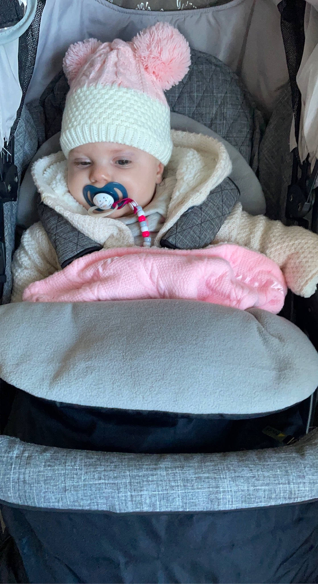 Esmae is registered to the contest to win money with this photo: baby, baby_carriage, baby_products, baby_sleeping, baby_toddler_clothing, cap, car_seat, cheek, child, comfort, headwear, knit_cap, linens, person, pink, product, seat_belt, sitting, textile, toddler
