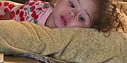 Scarlet joined the competition — help win amazing prizes! child, toddler, curly_hair, couch, pillow, blanket, indoor, relaxed, clothing, patterned, soft, resting, home, cozy, young_child, portrait, person, furniture, casual, comfort