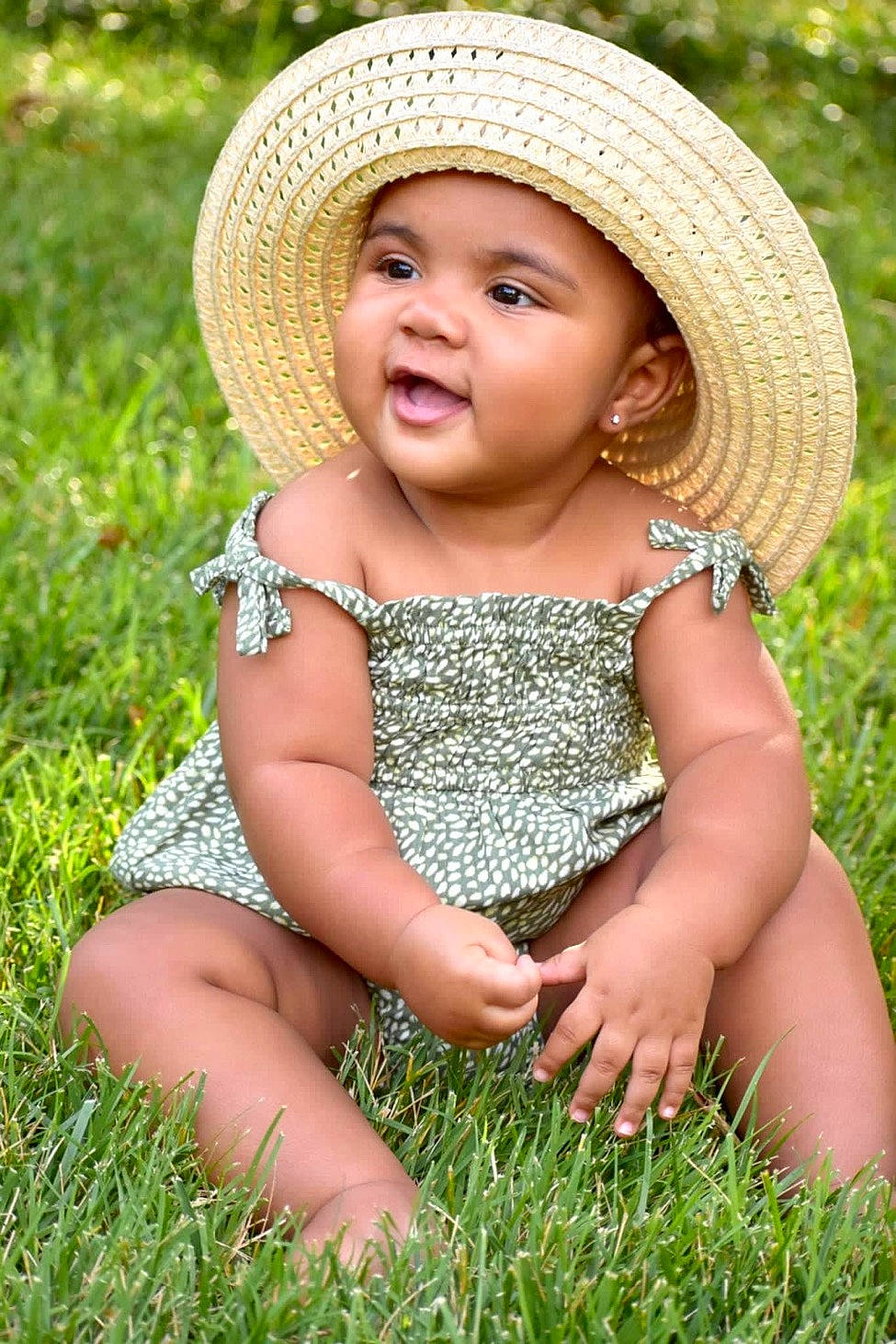 Cali joined the competition — help win amazing prizes! baby_toddler_clothing, child, dress, eye, face, facial_expression, grass, grass_family, grassland, happy, hat, headwear, meadow, people_in_nature, person, photograph, plant, rural_area, skin, summer