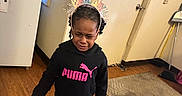 Kylie is registered to the contest to win money with this photo: barefoot, birthday, broom, child, crying, decorations, door, emotional, floor, fridge, headband, homedecor, hoodie, indoor, leggings, person, puma, rug, window, wood_floor