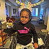 Kylie joined the competition — help win amazing prizes! child, birthday, headband, puma_hoodie, table, tablecloth, living_room, couch, tv, banner, celebration, indoor, person, expression, upset, clothing, furniture, decorations, holiday, party