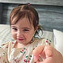 bed, bedroom, child, cute, eyebrows, face, floral_dress, funny_expression, girl, hair_tie, hand, indoor, person, pillow, pointing, portrait, skin, smile, toddler, young_child