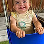 toddler, child, swing, blue, smile, happy, outdoor, wooden_fence, grass, shirt, flower, playground, metal_chain, cute, baby, portrait, daylight, casual_clothing, fun, person