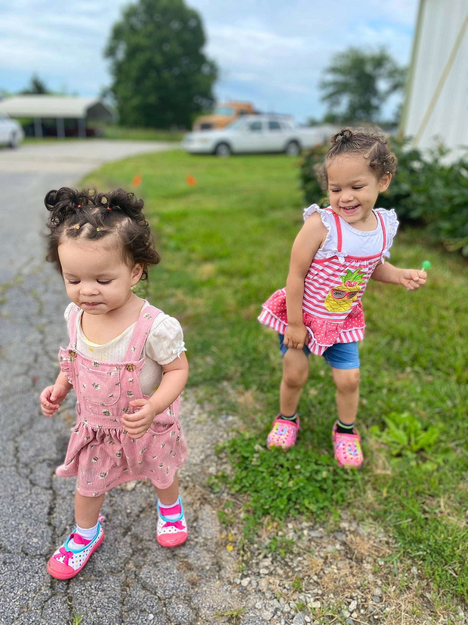 Armani is registered to the contest to win money with this photo: baby_toddler_clothing, car, eye, footwear, fun, grass, happy, joy, leg, leisure, people_in_nature, person, pink, plant, shoe, shorts, skin, sky, sneakers, standing