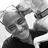 affection, animal, bald, black_and_white, closeup, collar, dog, face, friendship, glasses, happy, head, human, man, outdoor, pet, portrait, shoulder, smile, tongue