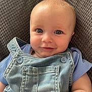 Jensen joined the competition — help win amazing prizes! baby, child, infant, face, smile, blue_eyes, denim, overalls, clothing, cute, portrait, sitting, texture, background, happy, person, young, closeup, apparel, casual