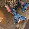 Masie is registered to the contest to win money with this photo: casual_wear, child, clothing, curious, cute, denim, fashion, flared_pants, floor, footwear, indoor, jeans, leopard_print, looking_away, person, sitting, small_child, toddler, trendy, young_child