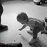 Rebekah joined the competition — help win amazing prizes! toddler, child, indoor, floor, toy_car, curious, squatting, shoes, adult, black_and_white, window, curtain, playtime, small_objects, person, footwear, light, home, flooring, candid