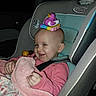 toddler, child, car_seat, toy, duck, blanket, pink_clothing, smile, bald_head, indoor, seatbelt, playful, baby_toy, child_seat, car_interior, person, cute, happy, infant, young_child