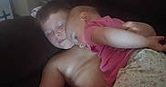 Rebekah joined the competition — help win amazing prizes! child, children, nap, sleeping, couch, sofa, indoor, shirtless, red_shorts, pink_shirt, floral_pants, siblings, family, cozy, resting, arm, skin, face, head, closeup