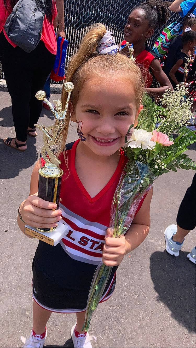 Devyn is registered to the contest to win money with this photo: blond, championship, cheerleading, cheerleading_uniform, child, competition_event, event, fun, hair, happy, jewellery, joy, people, person, smile, sneakers, sports, sports_uniform, team_sport, toddler