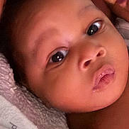 Zyaire is registered to the contest to win money with this photo: baby, close_up, face, infant, skin, eyes, mouth, nose, towel, soft, newborn, child, portrait, cute, expression, resting, young, human, person, indoors