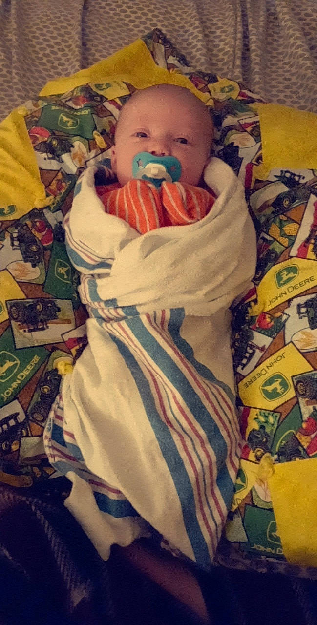 Daxton is registered to the contest to win money with this photo: baby, baby_products, baby_safety, baby_sleeping, baby_toddler_clothing, bedtime, cheek, child, comfort, eye, fun, happy, human_body, iris, linens, nose, person, room, sitting, textile