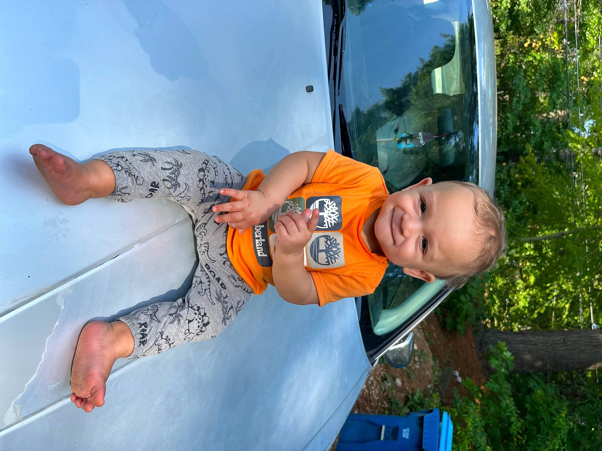 Javon is registered to the contest to win money with this photo: automotive_exterior, automotive_lighting, child, electric_blue, family_car, fun, grass, happy, hat, joy, leisure, person, personal_protective_equipment, plant, recreation, smile, t_shirt, toddler, tree, vacation