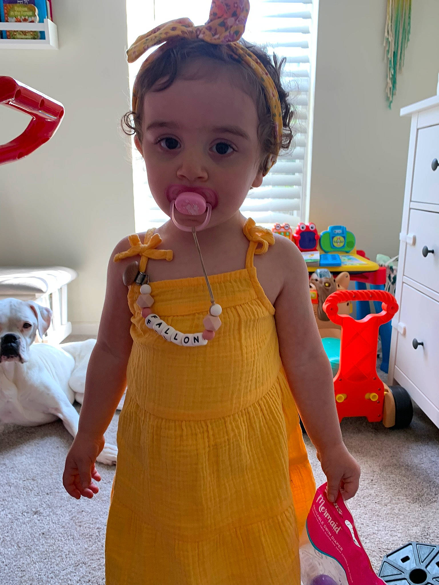 Fallon is registered to the contest to win money with this photo: bag, cabinetry, child, costume, cupboard, drawer, fashion_accessory, fashion_design, flooring, fun, jewellery, luggage_and_bags, necklace, orange, pattern, peach, person, room, sleeve, toddler