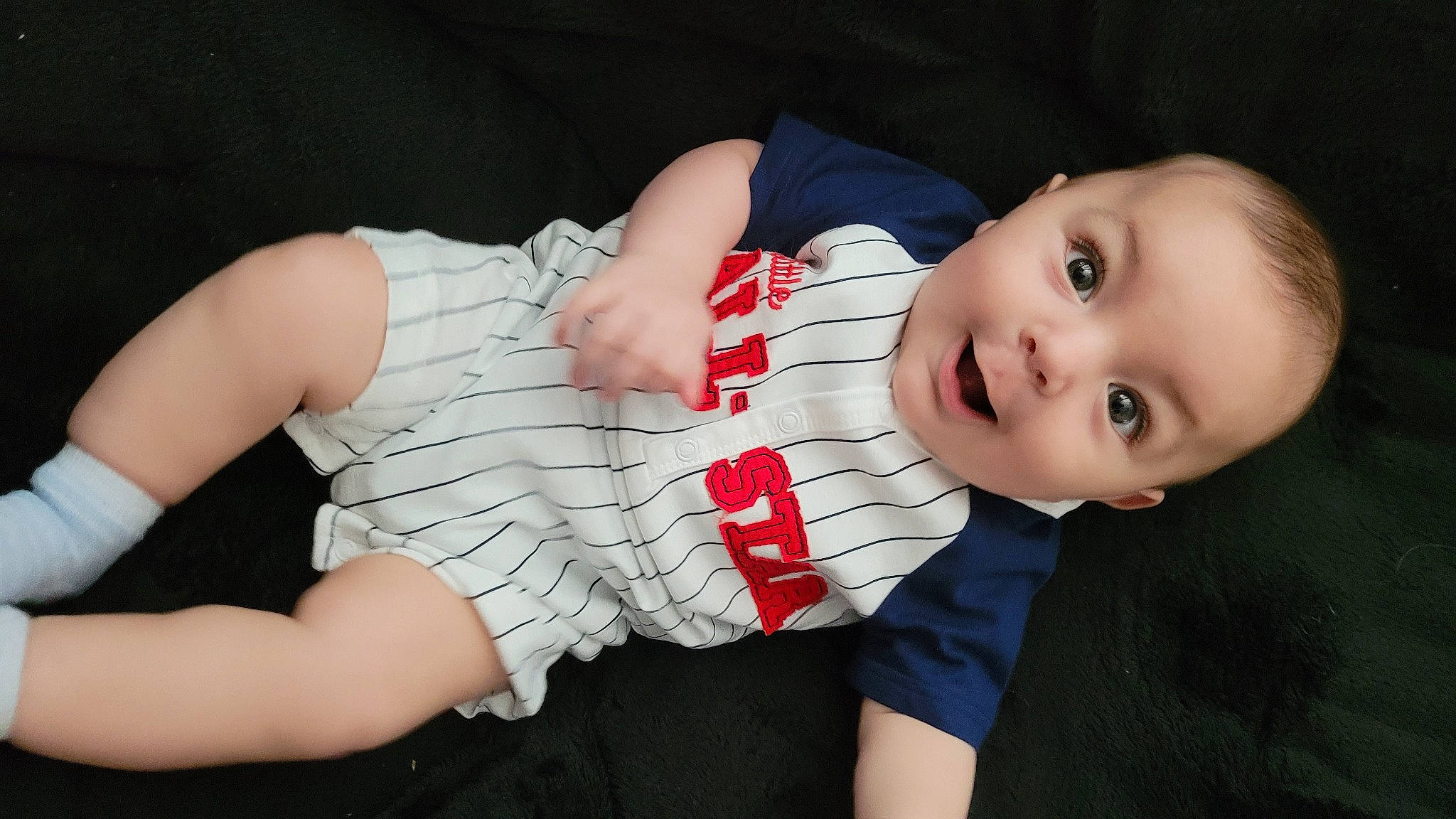 Lucas is registered to the contest to win money with this photo: baby, baby_toddler_clothing, cheek, comfort, dress, elbow, eye, finger, flash_photography, gesture, happy, head, lip, nail, person, skin, sleeve, smile, textile, thumb