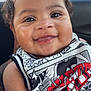 Levi joined the competition — help win amazing prizes! baby, child, smiling, curly_hair, drool, tank_top, graphic_tshirt, close_up, face, eyes, skin, arm, sitting, car_interior, window, outdoor, daylight, cute, happy, infant