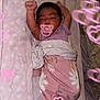 baby, sleeping, pacifier, blanket, pink, floral, arms_up, cozy, bed, cute, infant, wrapped, soft, heart_overlay, peaceful, newborn, toddler, indoors, resting, child