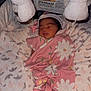 Ellie is registered to the contest to win money with this photo: baby, newborn, sleeping, blanket, pink, floral, soft_toys, cozy, bedding, infant, cute, peaceful, wrapped, sleep, child, indoors, portrait, rest, comfort, nursery