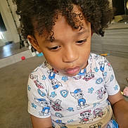 Zyair joined the competition — help win amazing prizes! child, curly_hair, indoor, carpet, toy, cartoon_clothing, focused, sitting, person, casual_wear, home, young_child, cute, toddler, short_sleeve_shirt, playtime, colorful, floor, relaxed, interior