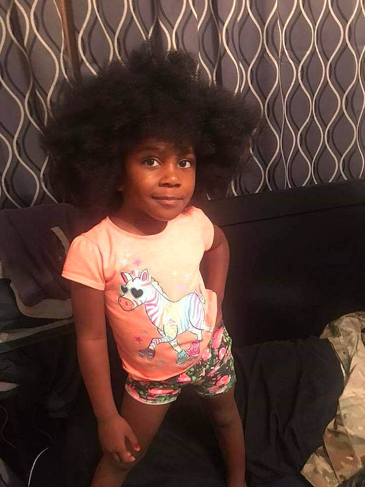Starr is registered to the contest to win money with this photo: afro, black_hair, child, cool, fun, hair, hairstyle, head, human, long_hair, person, sitting, skin, smile, toddler