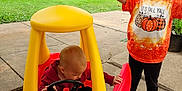 Kenslea joined the competition — help win amazing prizes! child, baby, toy_car, outdoor, play, grass, sidewalk, tree, leaf, fall_clothing, pink_shoes, red_car, yellow_roof, happy, smiling, person, nature, house, suburb, daylight