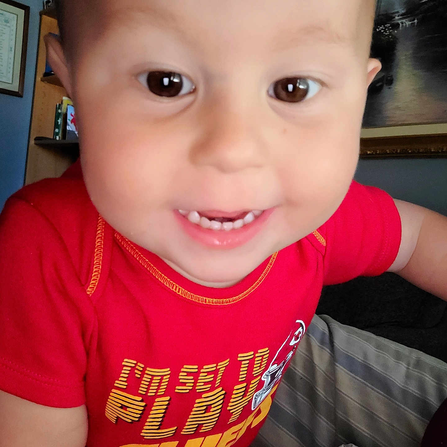 Jordan joined the competition — help win amazing prizes! baby_teeth, brown_eyes, casual_clothing, child, close_up, cute, expression, face, furniture, happy, home, indoor, person, portrait, red_shirt, short_hair, sitting, smiling, toddler, young_child