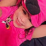 child, girl, smiling, pink_clothing, hat, minnie_mouse, happy, face, portrait, cute, indoor, dark_hair, playful, joyful, toddler, apparel, person, fashion, closeup, cheerful