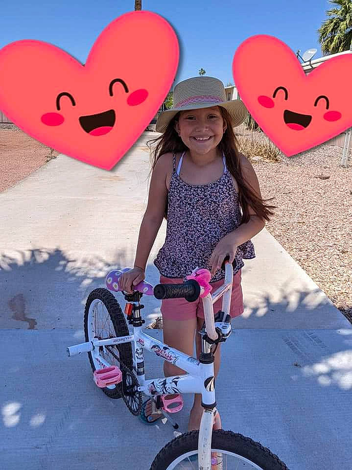 Sarai is registered to the contest to win money with this photo: bicycle, bicycle_frame, bicycle_handlebar, bicycle_saddle, bicycle_tire, bicycles_equipment_and_supplies, cool, happy, headwear, joy, light, organ, people_in_nature, person, photograph, pink, red, sky, smile, tire