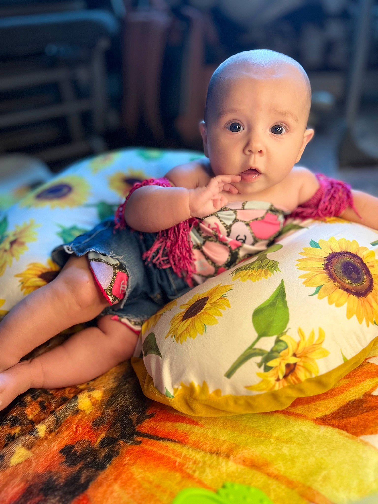 Bonnie is registered to the contest to win money with this photo: baby, baby_products, baby_toddler_clothing, beauty, chair, child, dress, facial_expression, grass, happy, human, linens, orange, pattern, people_in_nature, person, sitting, skin, surprise, sweetness