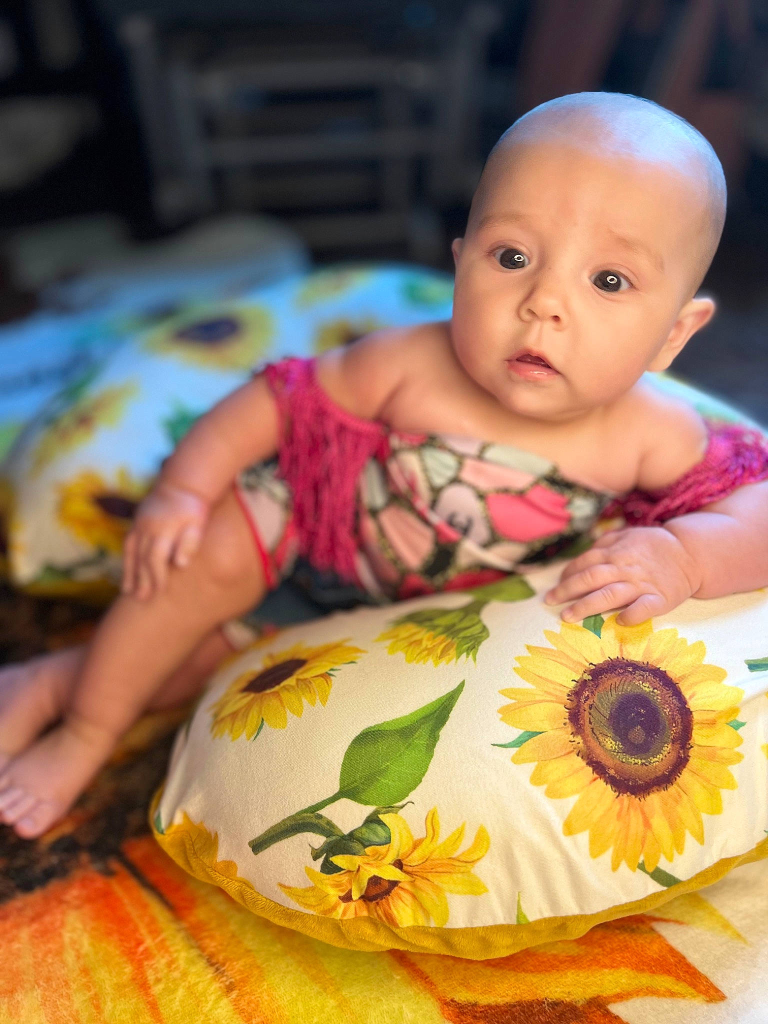 Bonnie is registered to the contest to win money with this photo: baby, baby_products, baby_safety, baby_toddler_clothing, cheek, child, eyelash, facial_expression, flower, fun, happy, iris, linens, orange, pattern, person, sitting, skin, sweetness, toddler