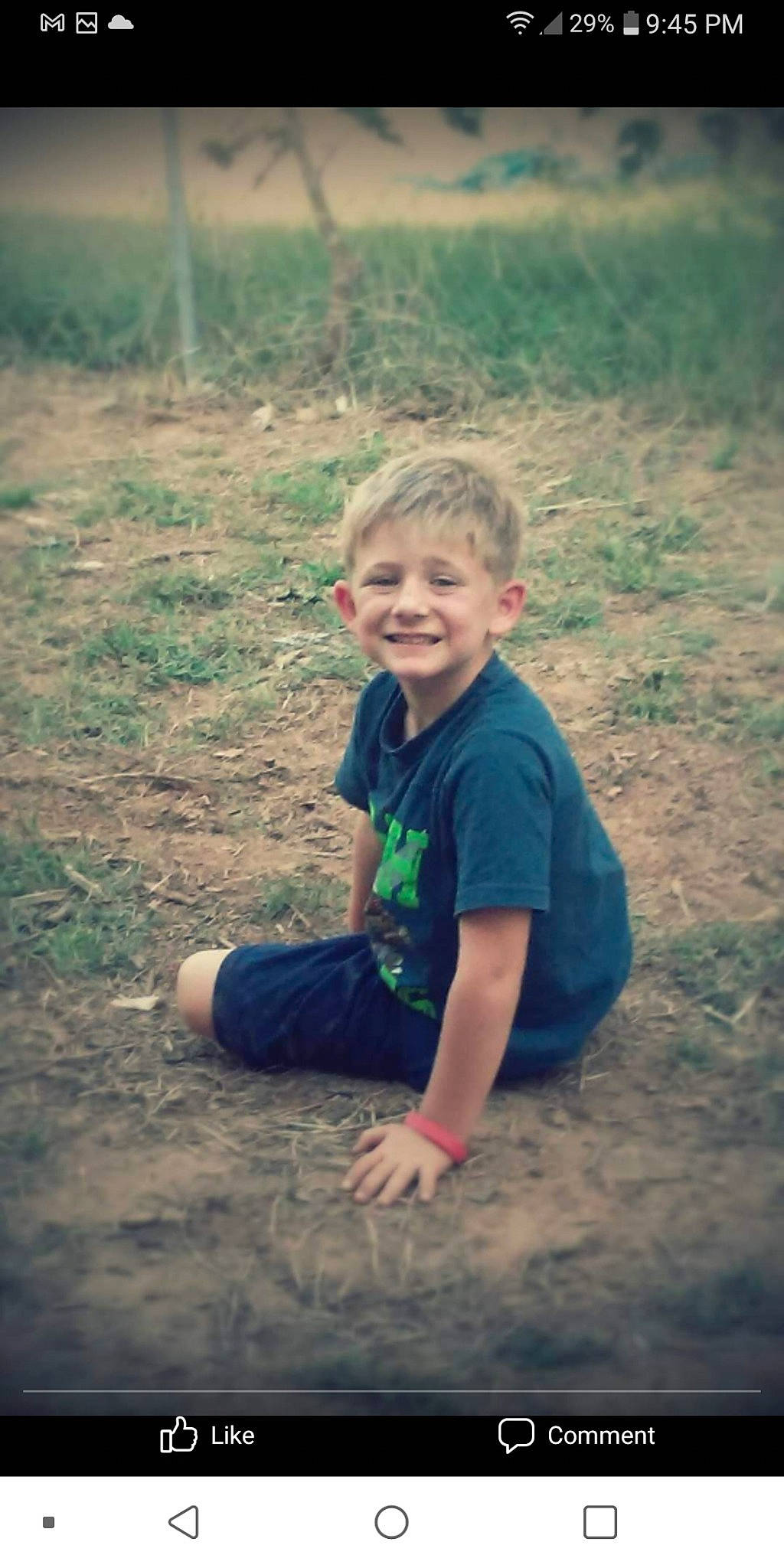 Landon is registered to the contest to win money with this photo: baby_toddler_clothing, barefoot, ear, eye, field, finger, foot, hand, happy, joy, laugh, mammal, people_in_nature, person, play, sand, soil, summer