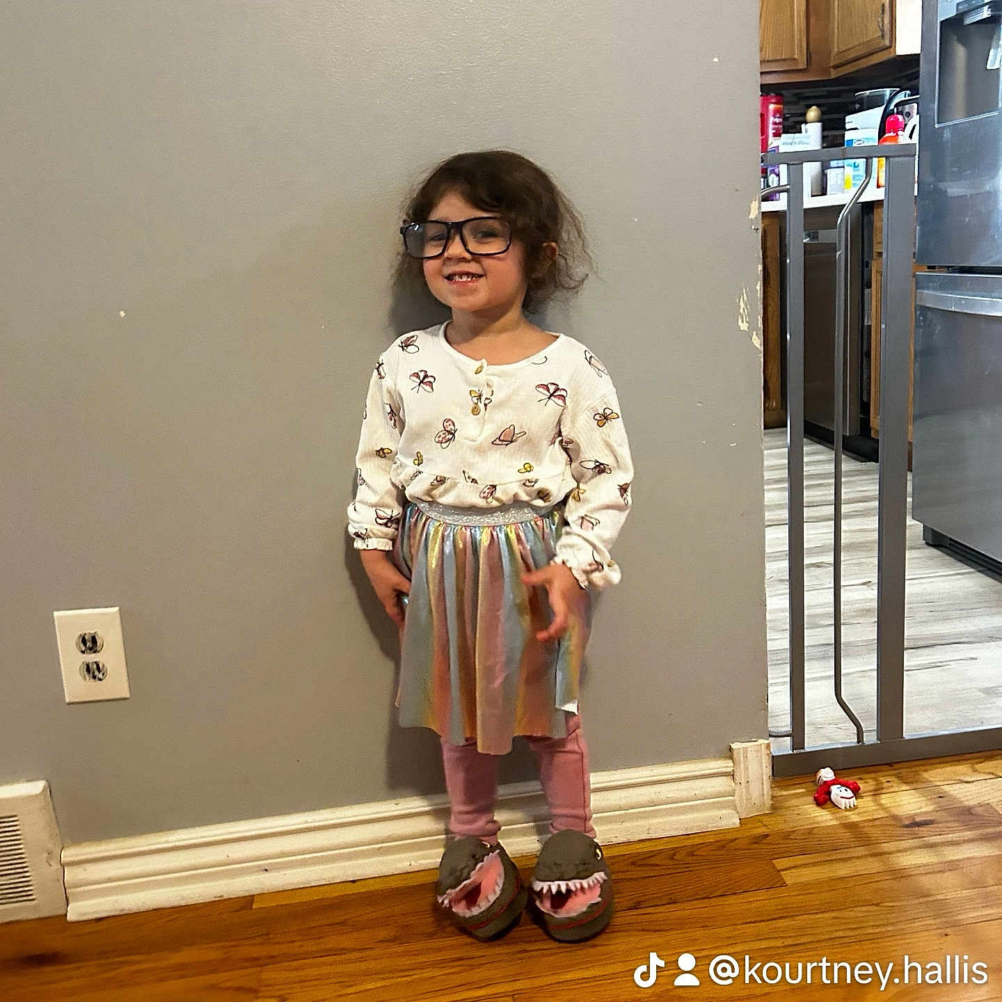 Nada is registered to the contest to win money with this photo: blouse, child, clothing, dress, face, female, footwear, girl, hardwood, head, indoors, interiordesign, pants, person, sandal, shoe, shorts, skirt, sleeve, wood