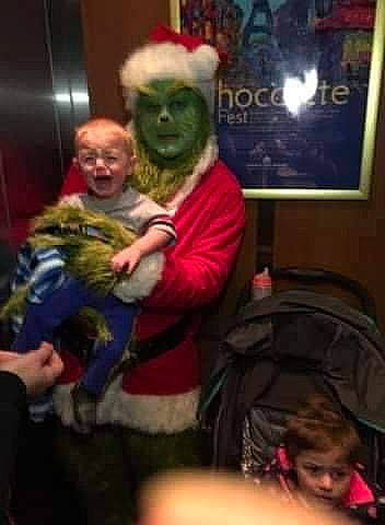 Angel is registered to the contest to win money with this photo: christmas, christmas_eve, costume, event, fictional_character, fun, fur, holiday, lap, person, picture_frame, room, santa_claus, sitting, t_shirt