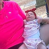 Cecelia is registered to the contest to win money with this photo: baby, infant, child, adult, person, pink_shirt, headband, red_headband, sleeping, outdoor, car, driveway, rock_garden, cross_necklace, tattoo, clothing, relaxing, summer, casual, portrait