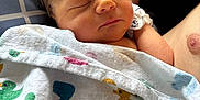 Desmond is registered to the contest to win money with this photo: arm, baby, blanket, child, closeup, comfort, cuddle, cute, duck_pattern, hair, indoor, infant, newborn, peaceful, person, portrait, rest, skin, sleeping, soft_light