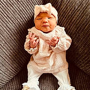 Zélie participe au concours pour gagner de l'argent avec cette photo : baby, infant, couch, clothing, headband, booties, white_clothes, frills, texture, soft_lighting, indoors, portrait, cute, small_hands, seated, comfortable, fashion, child, newborn, cozy