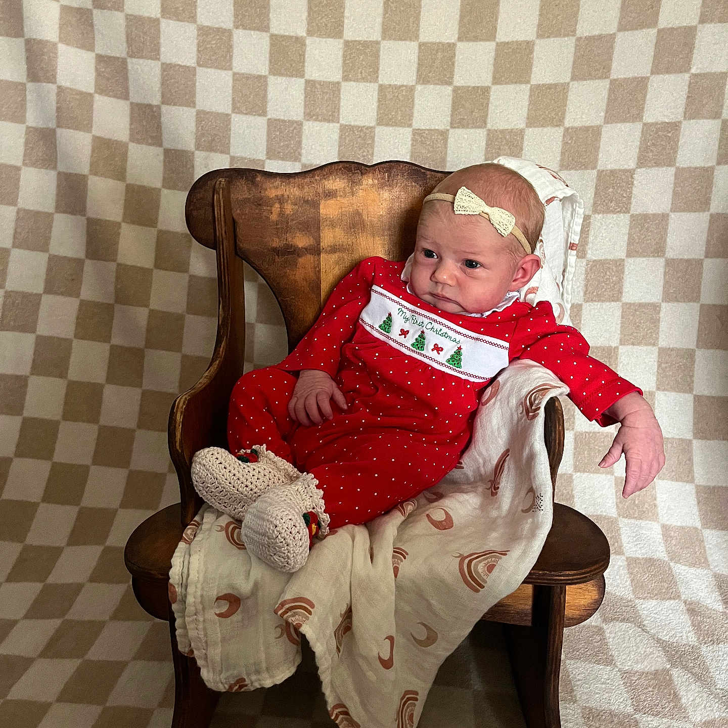 Kristina is registered to the contest to win money with this photo: baby, blanket, christmas_theme, cozy, cute, decor, headband, holiday, indoors, infant, newborn, patterned_background, portrait, red_clothing, relaxed, sitting, smiling, soft_lighting, warm, wooden_chair
