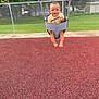 Roman is registered to the contest to win money with this photo: baby, casual_clothing, child, daylight, fence, fun, grass, greenery, happy, infant, joy, metal_chains, outdoor, park, play, playground, red_surface, smiling, summer, swing